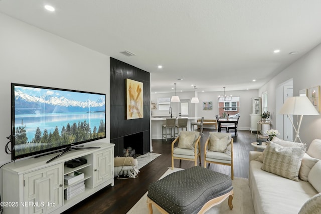 1407 Palmer Ter, Jacksonville, FL 32207 - living room with recessed lighting, dark wood-style flooring, and a chandelier