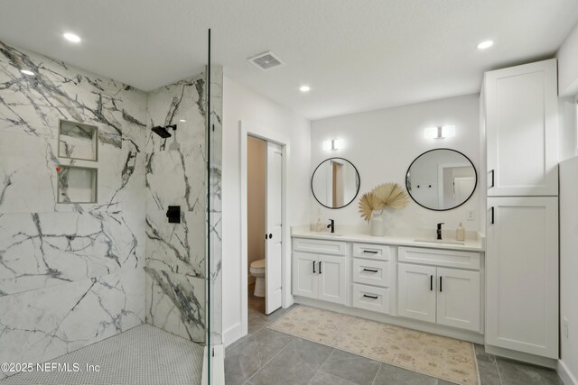 1407 Palmer Ter, Jacksonville, FL 32207 - bathroom with a marble finish shower, toilet, recessed lighting, double vanity, and tile patterned floors