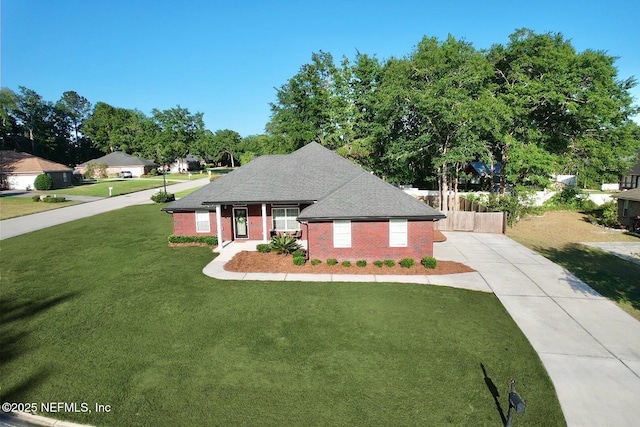 6128 Copper Ridge Cir, Macclenny, FL 32063 - view of front of house featuring concrete driveway, brick siding, fence, and a front lawn