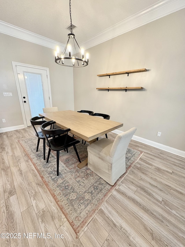 6128 Copper Ridge Cir, Macclenny, FL 32063 - dining area featuring baseboards, an inviting chandelier, ornamental molding, and light wood-type flooring