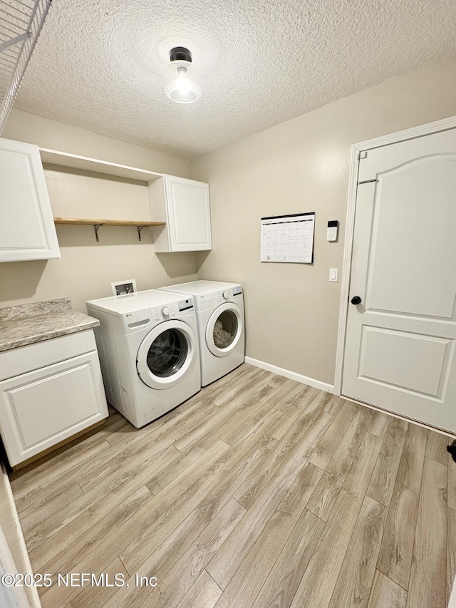 6128 Copper Ridge Cir, Macclenny, FL 32063 - laundry area featuring cabinet space, a textured ceiling, washing machine and dryer, and light wood finished floors