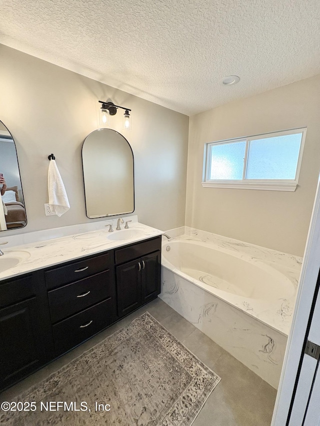 6128 Copper Ridge Cir, Macclenny, FL 32063 - bathroom featuring double vanity, a sink, a textured ceiling, and a garden tub