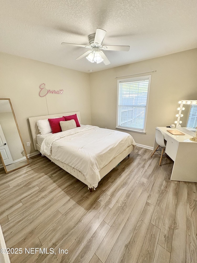 6128 Copper Ridge Cir, Macclenny, FL 32063 - bedroom featuring baseboards, a ceiling fan, a textured ceiling, and wood finished floors