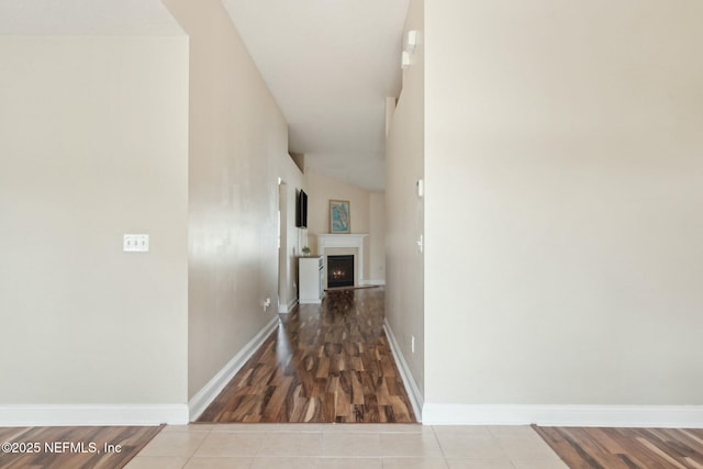 hall with wood finished floors and baseboards