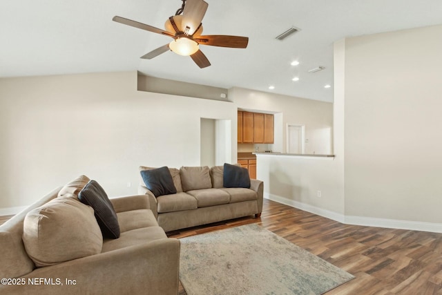 living room featuring visible vents, ceiling fan, wood finished floors, and baseboards