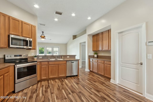 kitchen with recessed lighting, a ceiling fan, visible vents, appliances with stainless steel finishes, and wood finished floors