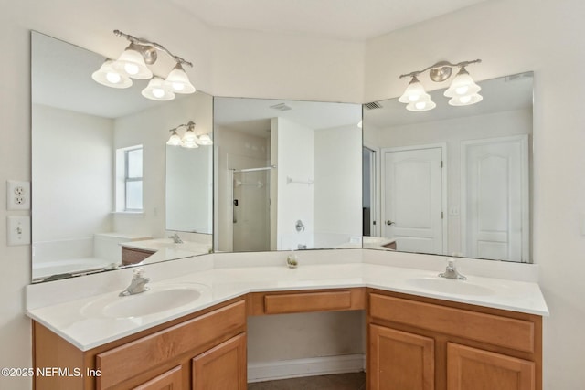 bathroom featuring a notable chandelier, a stall shower, and a sink