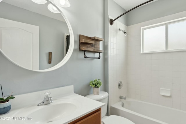 bathroom with shower / bathing tub combination, toilet, and vanity