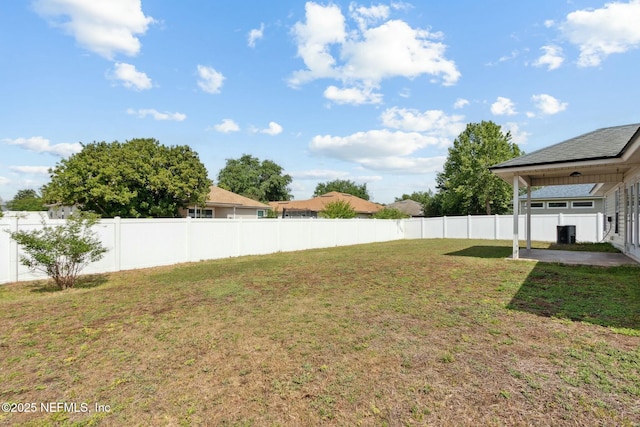 view of yard featuring a patio, a fenced backyard, and central AC unit