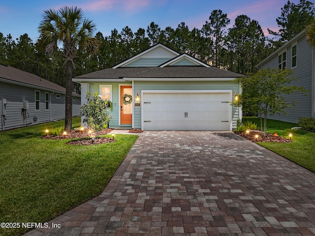 291 Greenway Ln, Saint Augustine, FL 32092 - view of front of house featuring an attached garage, decorative driveway, a yard, and a shingled roof
