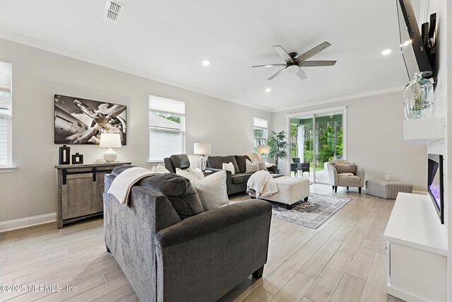 291 Greenway Ln, Saint Augustine, FL 32092 - living area featuring crown molding, light wood-style floors, a ceiling fan, and visible vents