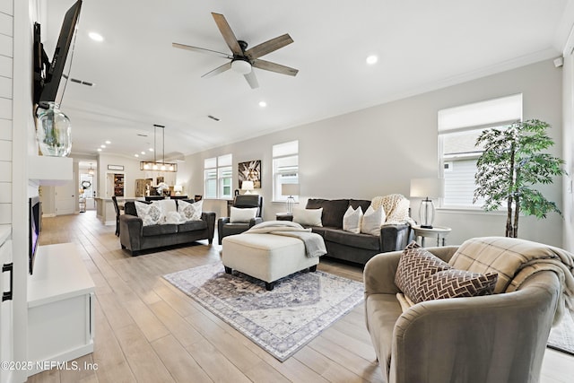 291 Greenway Ln, Saint Augustine, FL 32092 - living room with a ceiling fan, a fireplace, ornamental molding, recessed lighting, and light wood-style flooring