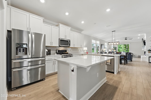 291 Greenway Ln, Saint Augustine, FL 32092 - kitchen with crown molding, appliances with stainless steel finishes, a center island, a peninsula, and open floor plan