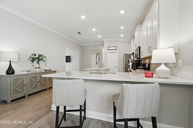 291 Greenway Ln, Saint Augustine, FL 32092 - kitchen with ornamental molding, decorative backsplash, recessed lighting, a sink, and stainless steel appliances