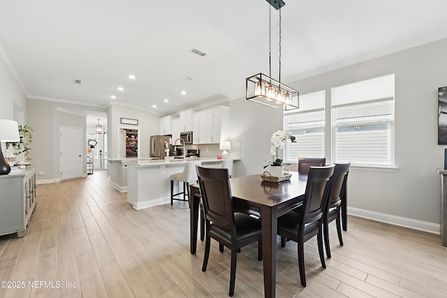 291 Greenway Ln, Saint Augustine, FL 32092 - dining room featuring visible vents, crown molding, baseboards, light wood finished floors, and recessed lighting