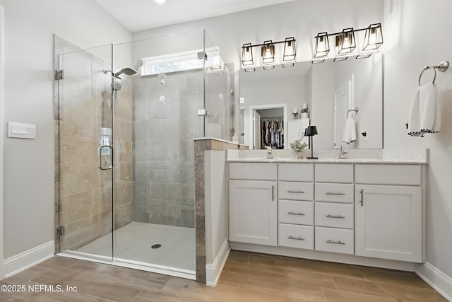 291 Greenway Ln, Saint Augustine, FL 32092 - full bathroom featuring double vanity, baseboards, a shower stall, and wood finished floors