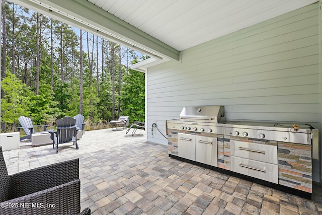 291 Greenway Ln, Saint Augustine, FL 32092 - view of patio with exterior kitchen, area for grilling, and an outdoor fire pit