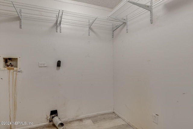 laundry area with light wood-style flooring, baseboards, laundry area, and hookup for a washing machine