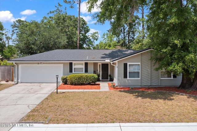 ranch-style house with a garage, a front lawn, fence, and concrete driveway