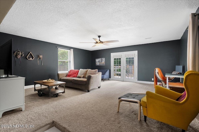 carpeted living room with baseboards, a textured ceiling, ceiling fan, and french doors