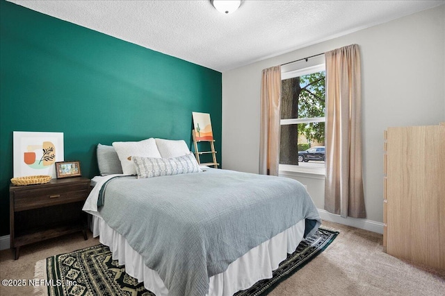 bedroom with baseboards, carpet flooring, and a textured ceiling