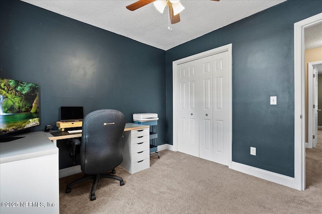 home office with baseboards, a ceiling fan, a textured ceiling, and carpet flooring