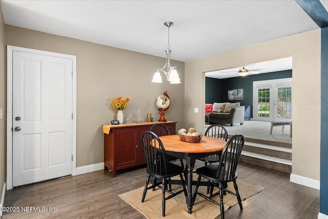 dining space featuring a ceiling fan, baseboards, wood finished floors, and a textured ceiling