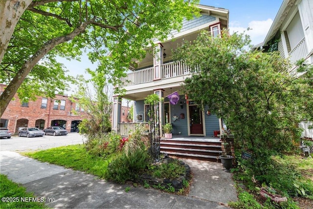 view of front facade featuring covered porch and a balcony