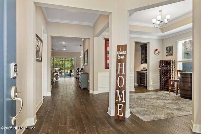 hallway with dark wood finished floors and ornamental molding