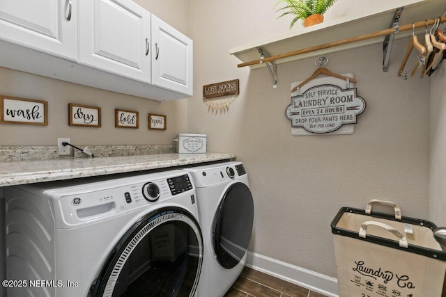 laundry room with baseboards, cabinet space, dark wood-style floors, and washing machine and clothes dryer