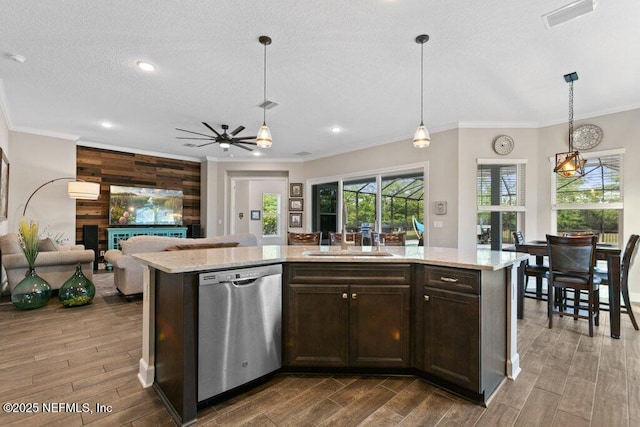 kitchen with dark brown cabinetry, a sink, a ceiling fan, stainless steel dishwasher, and visible vents