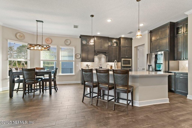 kitchen with crown molding, appliances with stainless steel finishes, and light countertops