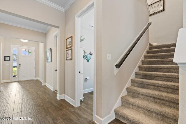 foyer entrance featuring stairs, baseboards, dark wood finished floors, and ornamental molding