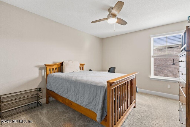 bedroom featuring baseboards, a textured ceiling, carpet, and ceiling fan
