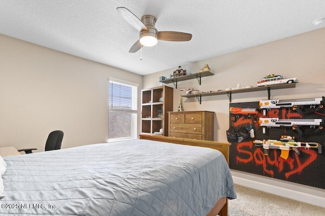 carpeted bedroom featuring a textured ceiling and ceiling fan