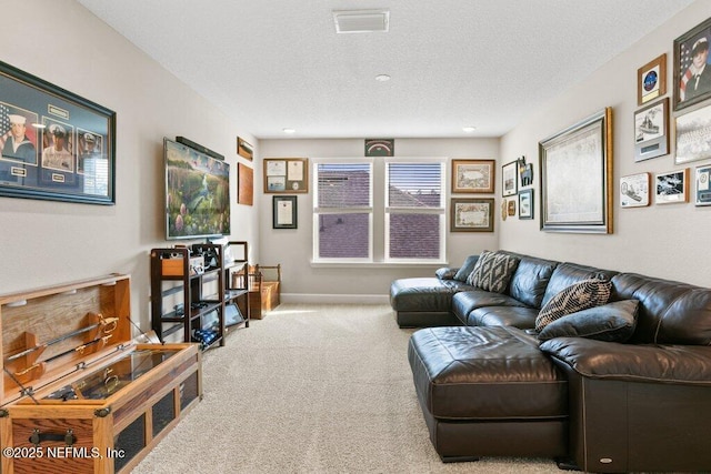 carpeted living area with visible vents, recessed lighting, a textured ceiling, and baseboards
