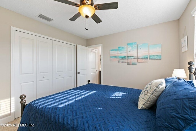 bedroom featuring carpet floors, a ceiling fan, a closet, and visible vents