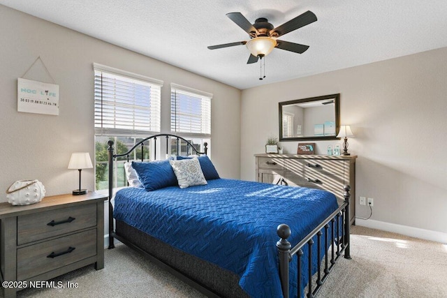 bedroom with carpet floors, a ceiling fan, baseboards, and a textured ceiling
