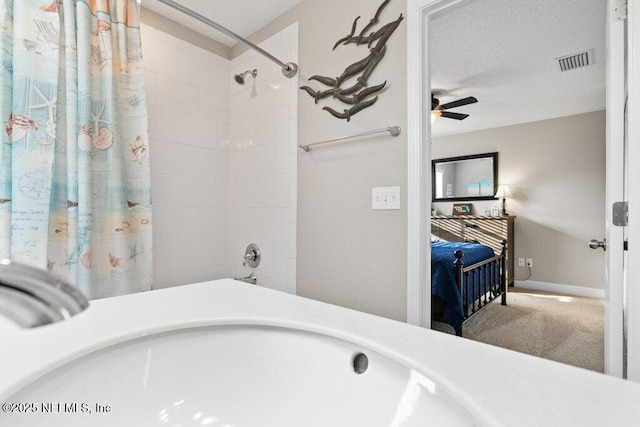 ensuite bathroom with ceiling fan, visible vents, shower / tub combo with curtain, and ensuite bath