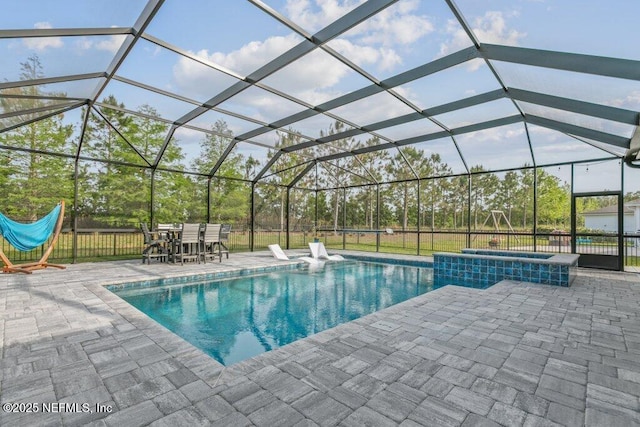 view of pool featuring a lanai, a pool with connected hot tub, a patio area, and outdoor dining space