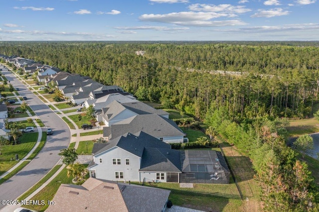 aerial view with a residential view and a wooded view