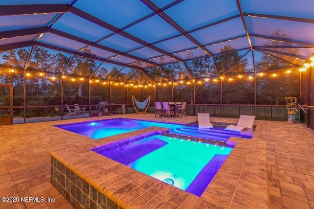 outdoor pool with glass enclosure, a patio, an in ground hot tub, and outdoor dining space