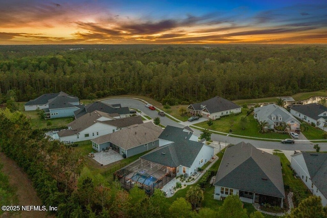 bird's eye view with a forest view and a residential view