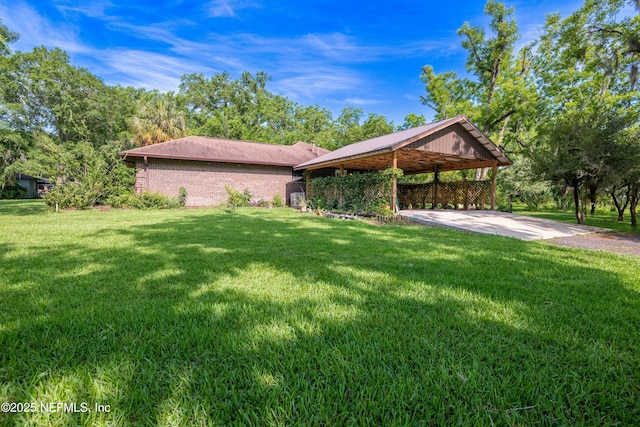 exterior space with brick siding, a front yard, driveway, and an attached carport