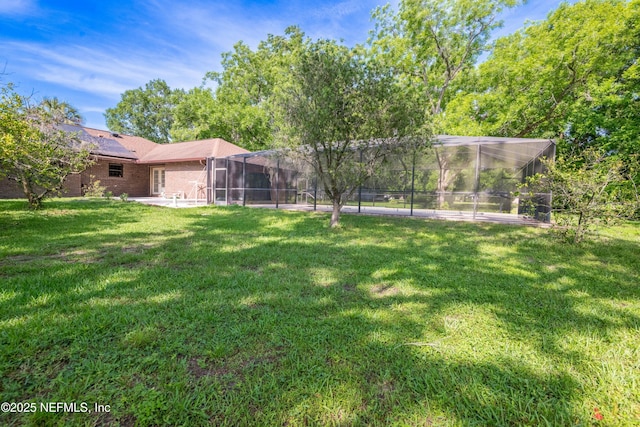 view of yard featuring a patio and a lanai