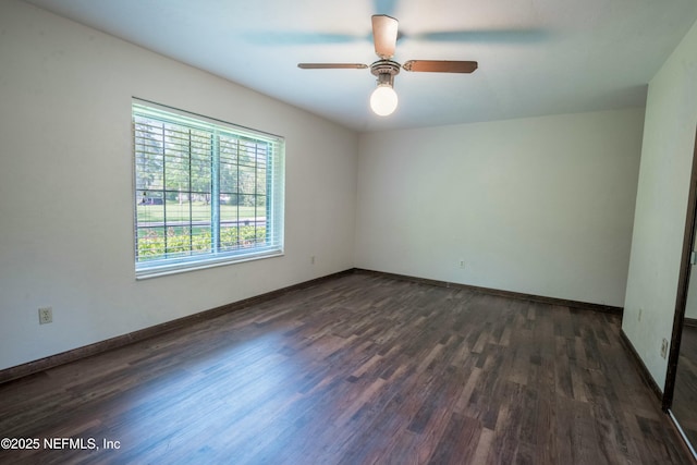 unfurnished room featuring baseboards, a ceiling fan, and dark wood-style flooring