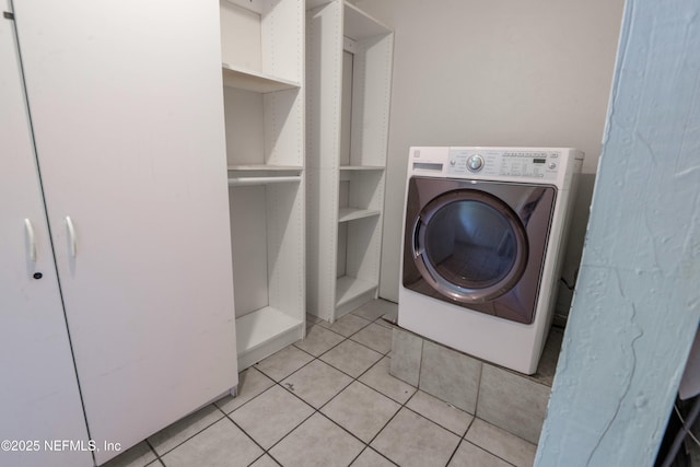 washroom featuring light tile patterned floors, washer / clothes dryer, and laundry area