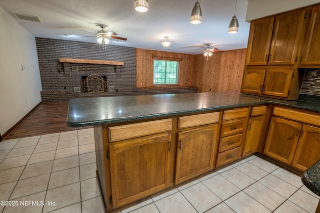 kitchen featuring visible vents, a ceiling fan, and brown cabinetry