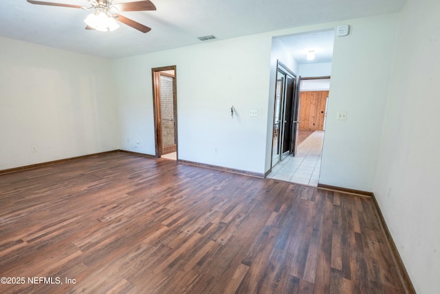 unfurnished bedroom featuring visible vents, ceiling fan, wood finished floors, and baseboards