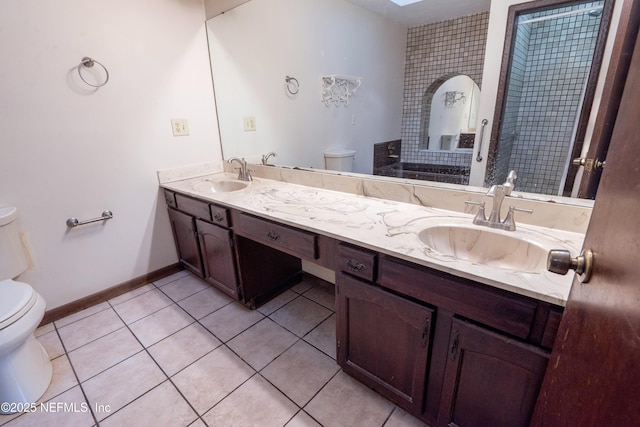 full bathroom featuring toilet, tile patterned flooring, and a sink